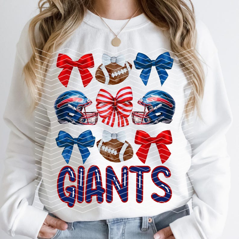 May include: White sweatshirt with a blue and red football helmet, red and blue bows, and a football with the word "GIANTS" in blue and red letters.