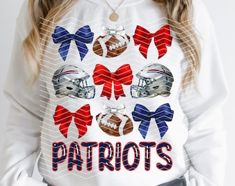 May include: White sweatshirt with a blue and red bow pattern, footballs, and helmets. The text "PATRIOTS" is printed in blue on the front of the sweatshirt.