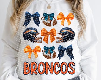 May include: White sweatshirt with a graphic design featuring orange and blue football helmets, blue and orange bows, and a football. The text "BRONCOS" is printed in orange on the front of the sweatshirt.