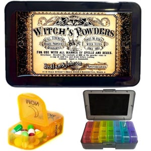Op de afbeelding: Een zwarte metalen doos met een vintage label waarop "Witch's Powders" staat en de tekst "Bedlam & Johnson Apothecaries 13 High Street Back Door Sandwich, Mass." De doos is open en onthult een gele pillendoos met een halve maan ontwerp en een zwart-witte pillendoos met zeven compartimenten.