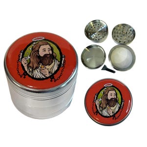 May include: A silver and red herb grinder with a detailed illustration on the lid. The image features a religious figure with a halo. The grinder is disassembled, showing the various components.
