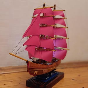 Handcrafted Wooden Sailing Ship Model with Red Sails – Nautical Decor with LED Lights