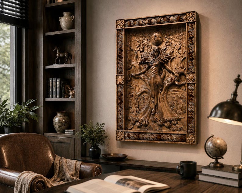 May include: A detailed, brown wooden relief carving of a woman with outstretched arms, set within a decorative frame. The artwork is mounted on a wall in a room with a desk, bookshelves, and a leather armchair. The room is well-lit with natural light.