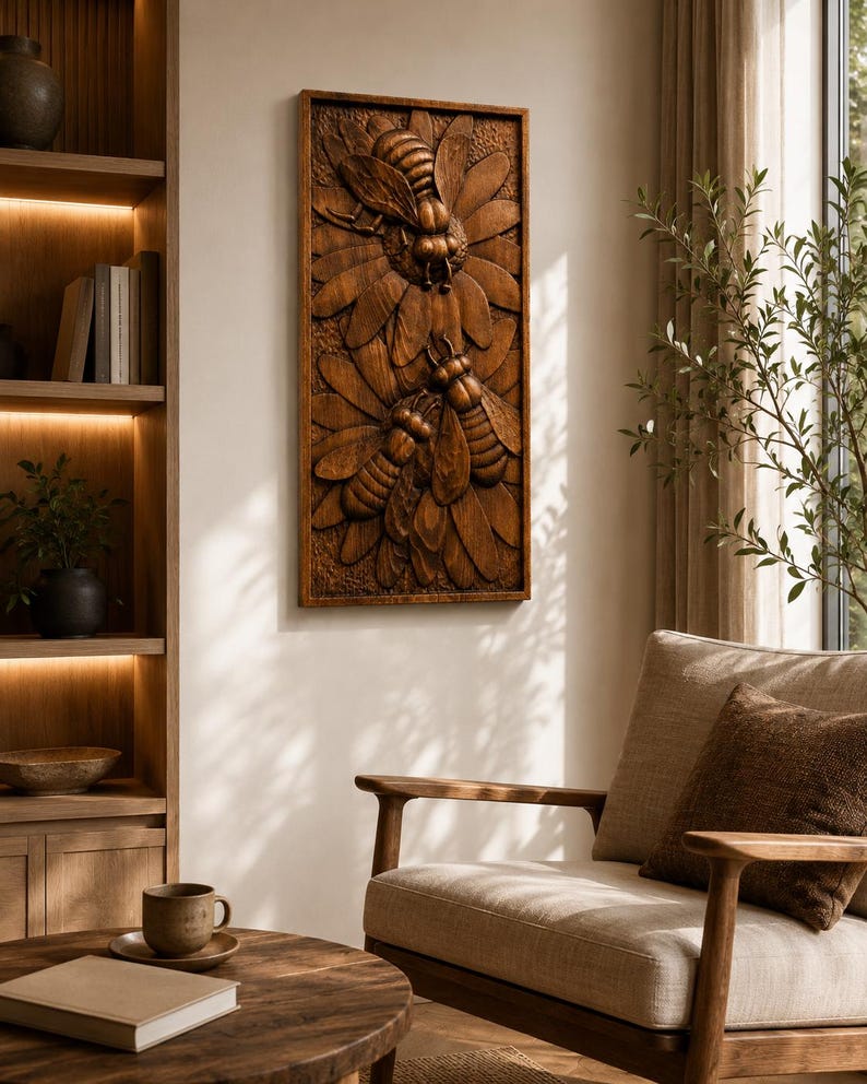 May include: A rectangular wooden wall art piece with a detailed relief carving of two bees and stylized flowers. The artwork is stained a warm brown colour and is mounted on a neutral-coloured wall. The piece adds a natural, rustic element to the room.