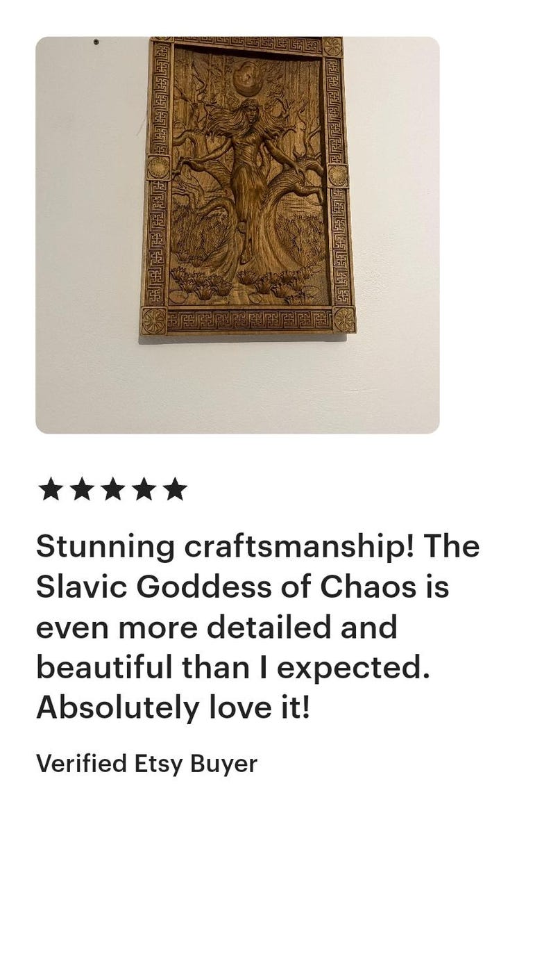 May include: A wooden carving of the Slavic Goddess of Chaos, framed with an ornate border. The artwork depicts a female figure with flowing hair, surrounded by a tree and other natural elements. The carving is detailed and intricate.