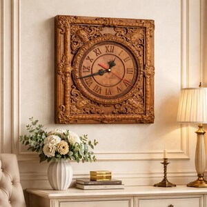 May include: A square, wooden wall clock with an ornate, carved frame. The clock face is a lighter shade of brown with Roman numerals and black hands, and a red second hand. The clock is mounted on a cream-colored wall.