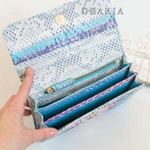 open python leather wallet with card slots, bill compartments and zip pocket inside