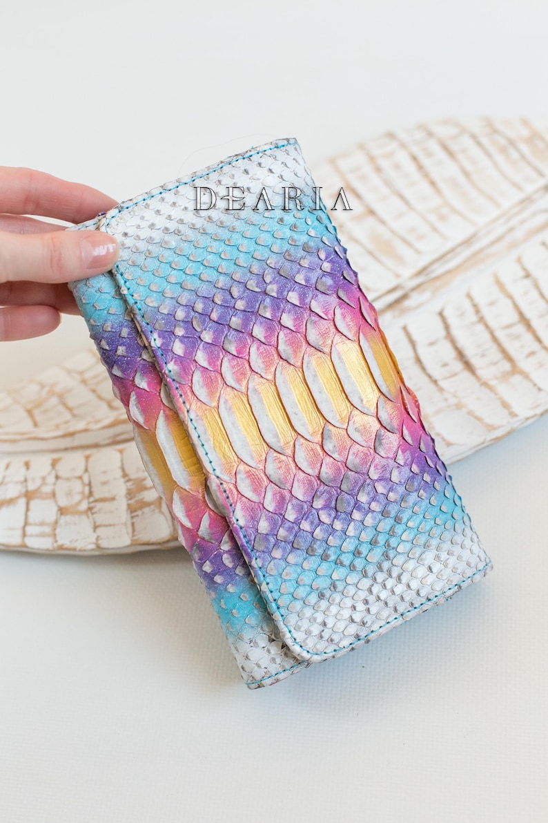 vibrant snakeskin wallet in hand showing scale pattern and colors