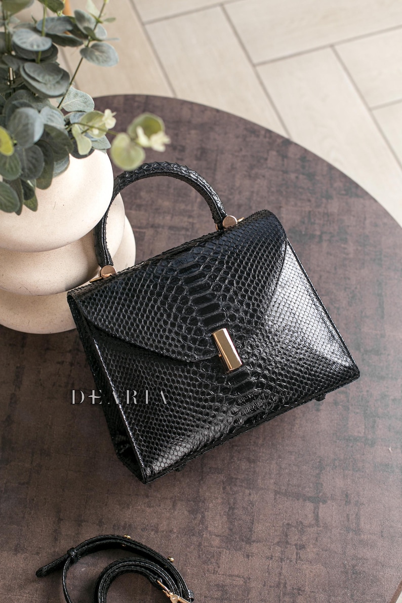 Luxury black glossy python leather handbag with gold hardware