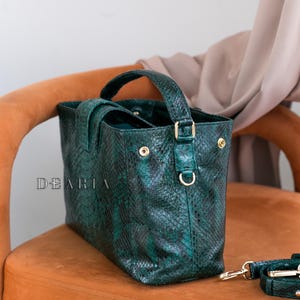 Side view of emerald python handbag showing soft structure