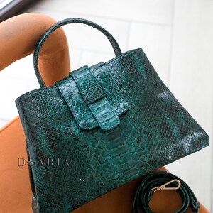 Women’s snakeskin handbag showing rich emerald green color