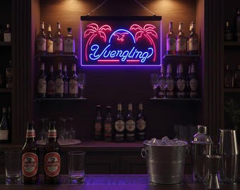 May include: A neon sign with the word "Yuengling" in blue script, framed by a purple border and palm tree designs. The sign hangs above a bar with bottles, glasses, and a metal ice bucket. Two bottles of Yuengling beer are visible.