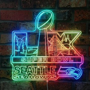 May include: A neon sign featuring the Super Bowl trophy, the text "SUPER BOWL", and "SEATTLE SEAHAWKS". The sign has a colorful gradient and includes images of the Seattle skyline, the Golden Gate Bridge, and a Seahawks logo.