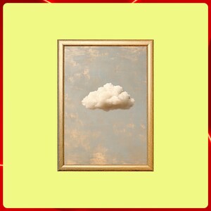 May include: A framed print depicting a single, fluffy white cloud floating in a pale blue sky. The artwork is set within a gold-coloured rectangular frame, enhancing the serene, minimalist aesthetic.