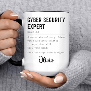May include: White ceramic mug with a black handle and rim. The mug features the text "CYBER SECURITY EXPERT" above a definition, and the name "Olivia" in cursive. A perfect gift for a cybersecurity professional.