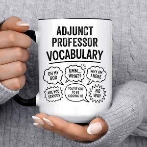 May include: White ceramic mug with black handle and rim, featuring the text "ADJUNCT PROFESSOR VOCABULARY" and various speech bubbles with phrases like "OH MY GOD" and "WHY AM I HERE".
