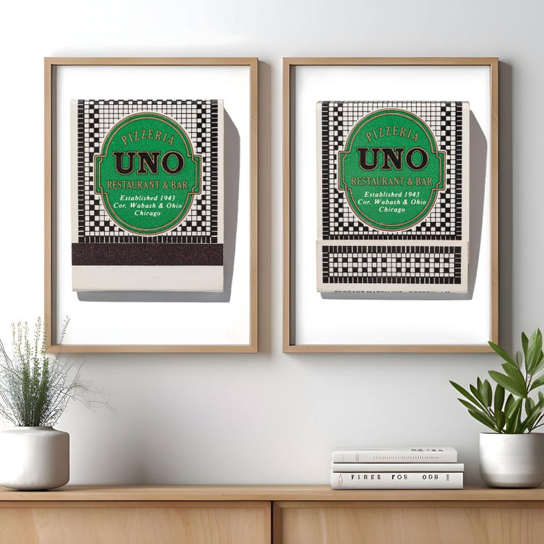 May include: Two framed prints featuring Pizzeria Uno Restaurant & Bar matchbook covers. Each print displays a green oval logo with black text reading Pizzeria Uno Restaurant & Bar, Established 1943, Cor. Wabash & Ohio, Chicago, over a black and white tile pattern.