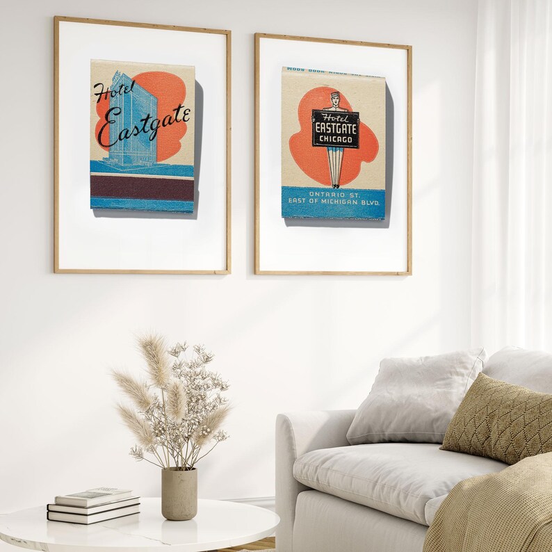 May include: Two framed prints of vintage matchbook covers advertising the Hotel Eastgate in Chicago. The left print shows a blue and white illustration of the hotel building. The right print shows a red and blue illustration of a bellhop holding a sign that says "Hotel Eastgate Chicago".