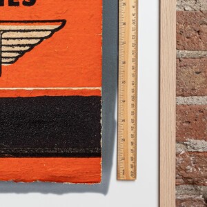 May include: A vintage orange and black book with the text "Series" on the cover. The book is slightly worn and has a ruler next to it.