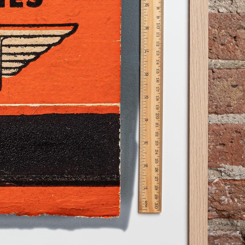 May include: A vintage orange and black book with the text "Series" on the cover. The book is slightly worn and has a ruler next to it.