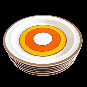 May include: A white ceramic mug with a black handle and the text "But First, Coffee" in a handwritten style. The mug is on a white surface. The mug is 4 inches tall.