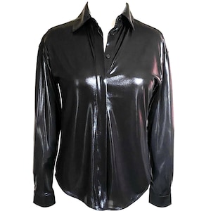 May include: A black long-sleeved shirt with a shiny, metallic finish. The shirt has a button-up collar and a button closure.