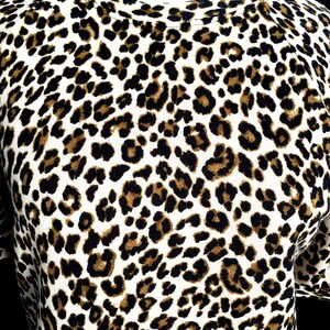 May include: A white, brown, and black leopard print shirt.