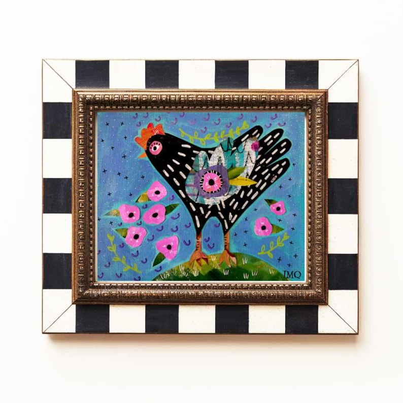 May include: A framed painting of a black chicken with colorful details, standing in a field of pink flowers against a blue background. The frame is black and white checkered.