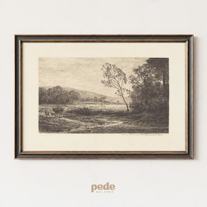 May include: Framed black and white landscape print. The artwork depicts a rural scene with trees, a winding path, and figures with a horse-drawn cart. The frame is black with a gold inner border. The print is mounted on a white wall.