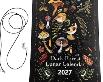 May include: A black spiral-bound 2027 Dark Forest Lunar Calendar featuring colorful illustrations of mushrooms, birds, ferns, and pinecones, accompanied by a thin black cord necklace with a silver-toned metal clasp and an adjustable chain link.