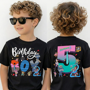 A young boy wearing a black t-shirt with a colorful graphic design and text on the front and back.