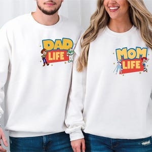a man and a woman wearing matching sweatshirts