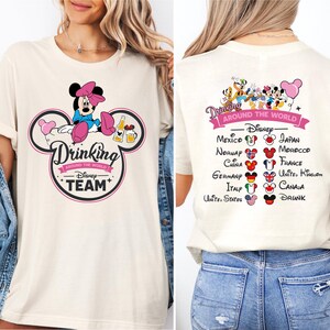 a woman wearing a mickey mouse shirt and jean shorts