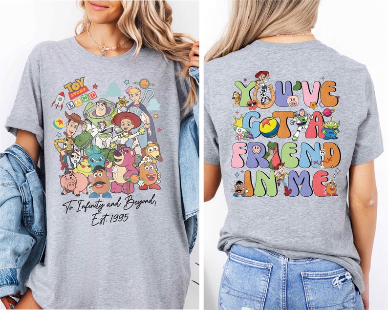 a woman wearing a grey tshirt with cartoon characters on it