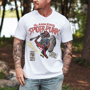 a man wearing a white shirt with a picture of a motorcycle rider on it