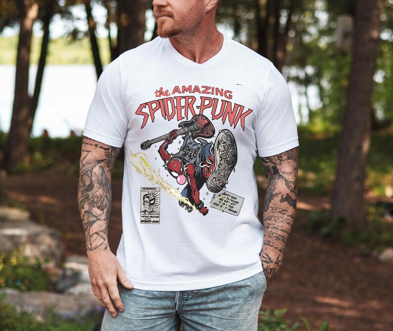 a man wearing a white shirt with a picture of a motorcycle rider on it