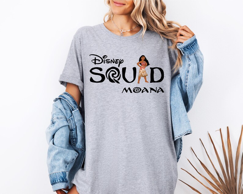a woman wearing a disney shirt with the word squad moan on it