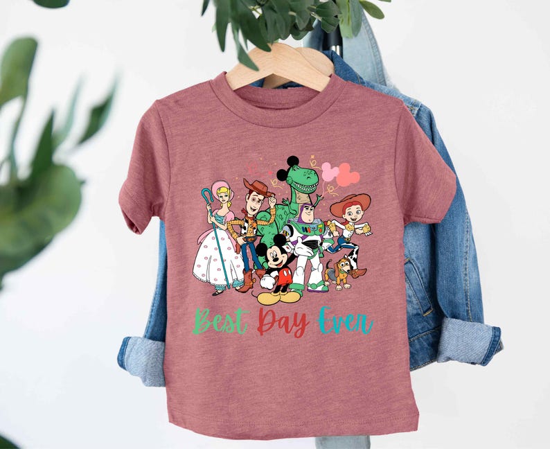 a pink t - shirt with cartoon characters on it
