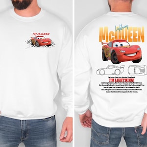 a man wearing a white sweatshirt with a cartoon character on it