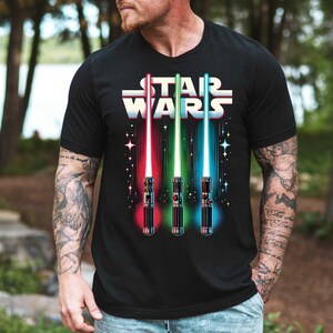 a man wearing a star wars t - shirt in the woods