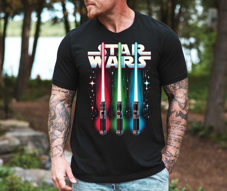 a man wearing a star wars t - shirt in the woods