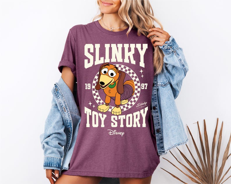 a woman wearing a shirt that says slinky is a toy story