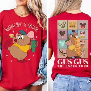 a woman wearing a red tshirt with an image of a mouse holding a