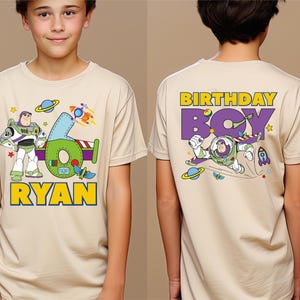 a young boy wearing a toy story birthday t - shirt