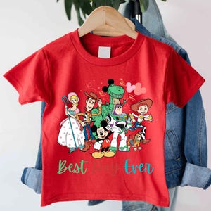 a red t - shirt with cartoon characters on it