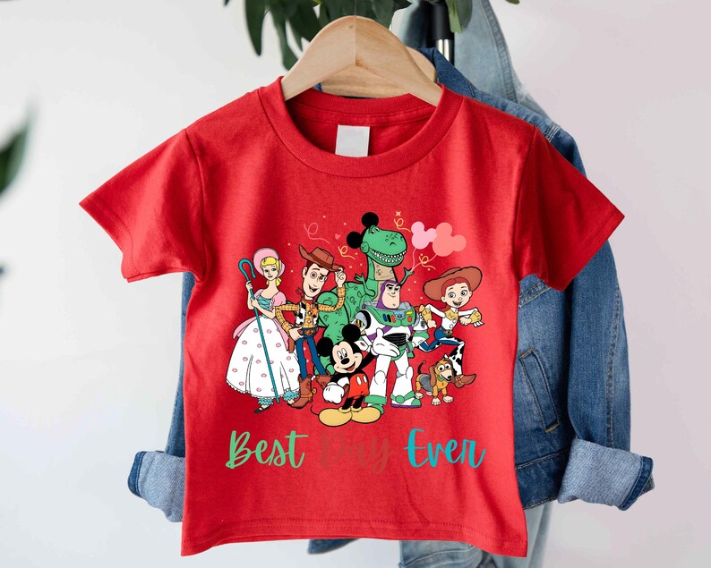 a red t - shirt with cartoon characters on it
