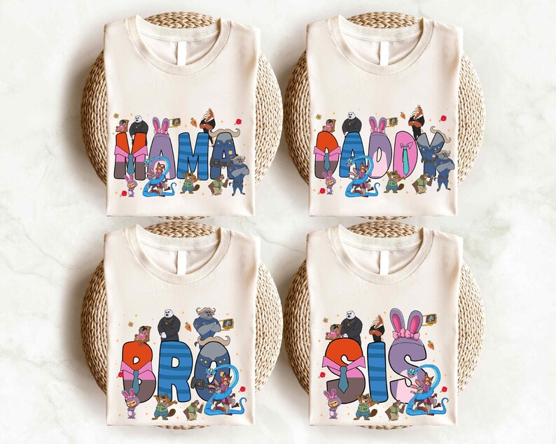 four white t-shirts with colorful text and illustrations, each featuring a different character or phrase.