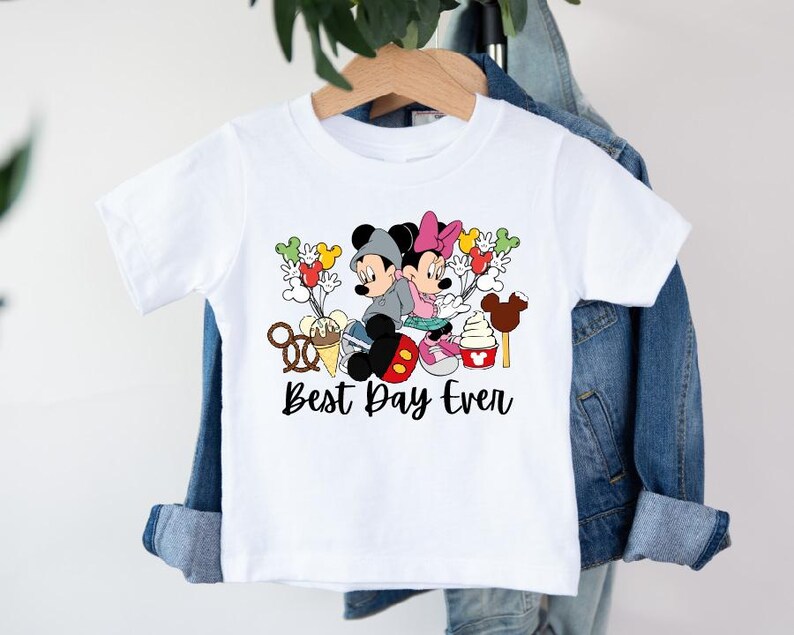 a white shirt with mickey mouse and minnie mouse on it