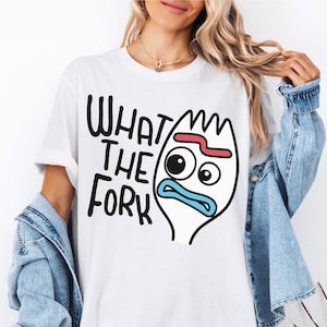 May include: White t-shirt featuring a cartoon image of a fork with a face and the text "What the Fork" printed on it.