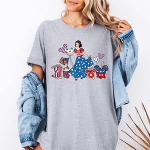 a woman wearing a t - shirt with a cartoon character on it